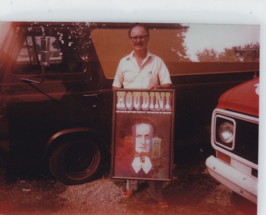 Paul Zill with a framed Houdini poster