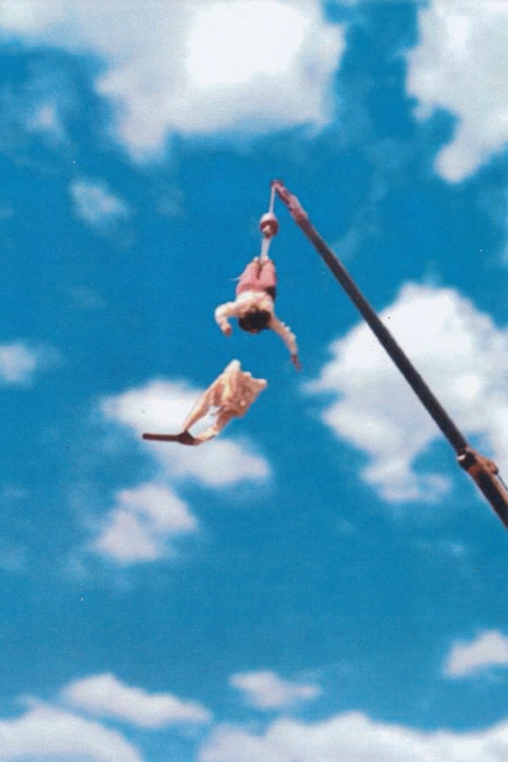 Straitjacket escape from a crane